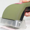 Axicon 6025 barcode verifier held left scanning a barcode side on