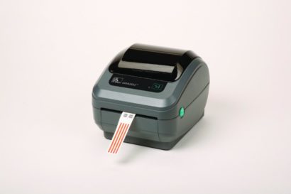 Zebra GX420D 203 Dpi Direct Thermal Desktop Label Printer Right Facing With Label