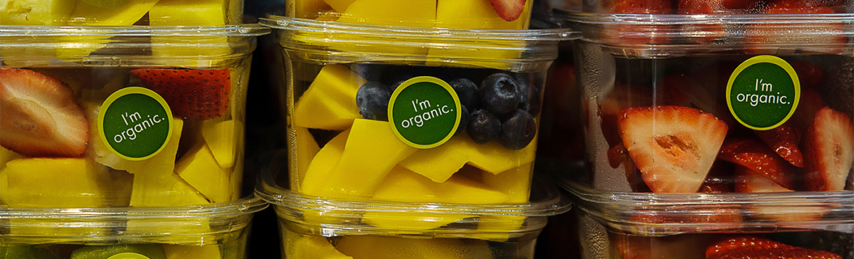 Examples of "I'm Organic" food labels on fruit storage containers.