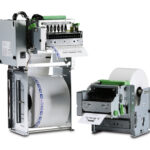 Image of the TUP500 Kiosk Printer with its internal components exposed, showing the paper roll, print head assembly, and electronic controls. The device is designed for high-speed printing applications in kiosks, retail, and industrial environments, featuring a compact and durable metal frame with green accents on key parts. The printer is ideal for ticketing, labeling, and transaction printing in busy service settings.