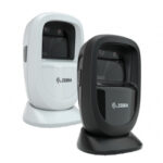 Angled view of two Zebra DS9300 1D/2D Presentation Barcode Scanners in black and white models, featuring a compact and modern design for hands-free operation. Designed for high-performance barcode scanning in retail and hospitality environments, the DS9300 offers fast and reliable capture of 1D and 2D barcodes in a durable and space-saving form factor.