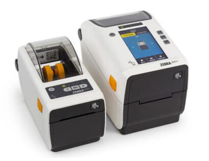 Two Zebra ZD611 Healthcare Printers. On the left is a compact direct thermal model with a transparent cover, and on the right is a larger unit featuring a color touchscreen and advanced navigation controls. Both printers are designed specifically for healthcare environments, offering disinfectant-ready housings and medical-grade power supplies for safe and reliable operation in applications like patient identification, specimen labeling, and medication management.