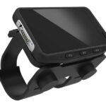 A compact, rugged Honeywell CW45 Wearable Mobile Computer mounted on a wrist strap, featuring a touchscreen display, side buttons labeled F1, F2, and F3, and a barcode scanner port. Designed for hands-free operation, it is ideal for logistics, retail, and manufacturing environments requiring real-time data capture and mobility.