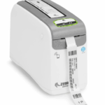 Zebra ZD510-HC healthcare wristband printer printing a patient ID wristband, designed for hospital and medical environments, featuring smart media technology and antimicrobial casing.